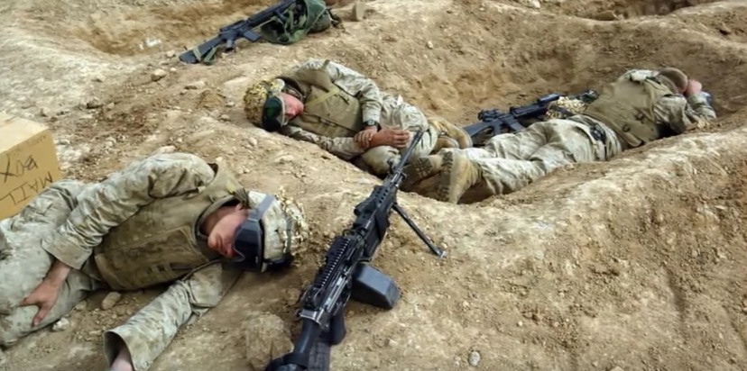military soliders lying in bunkers with backpain